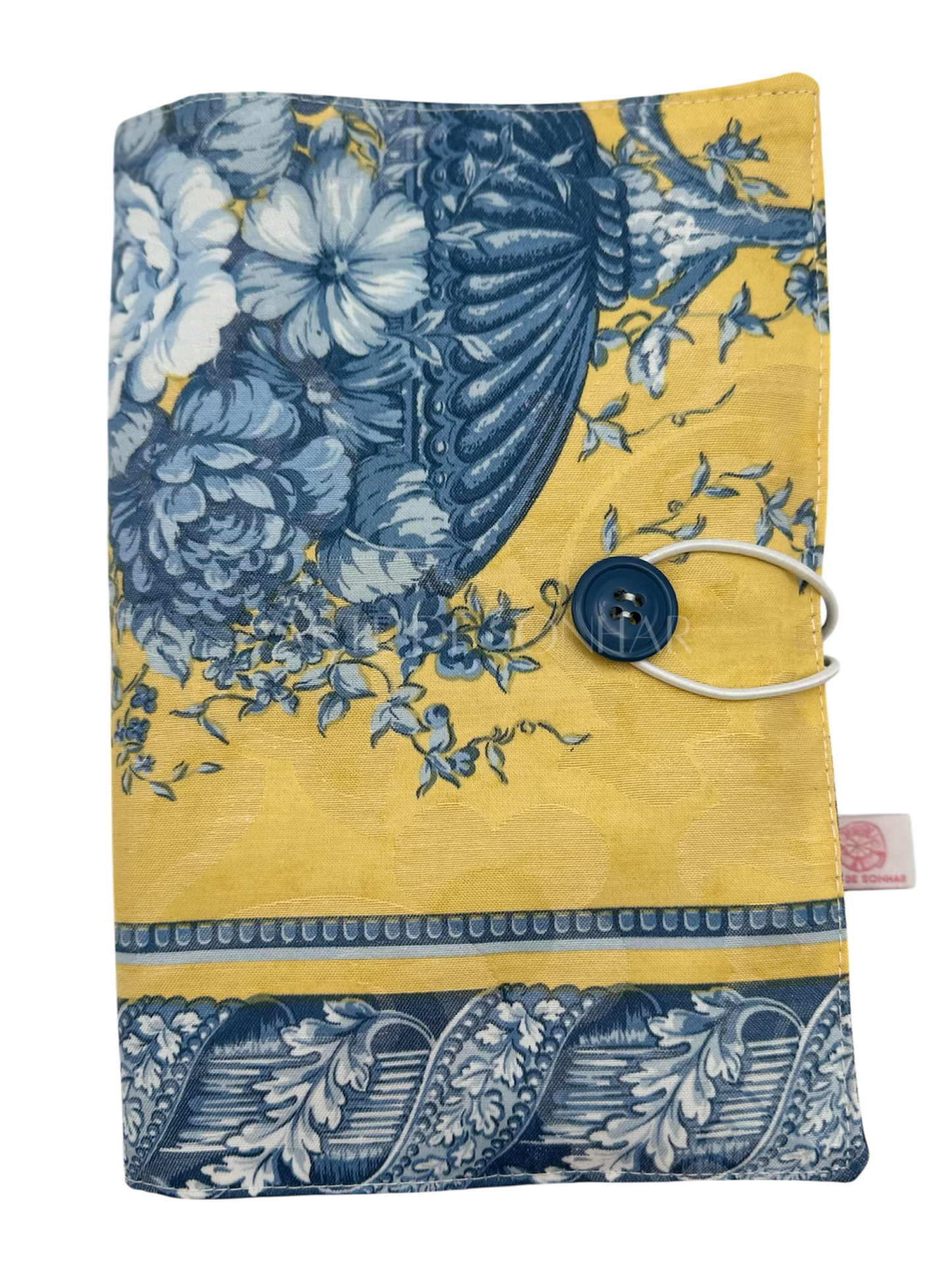 Capa de livro amarela com flores azuis