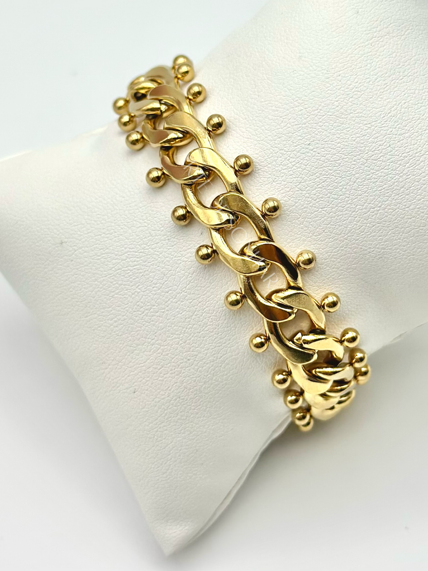 Pulseira dourada de malha aberta média com bolinhas