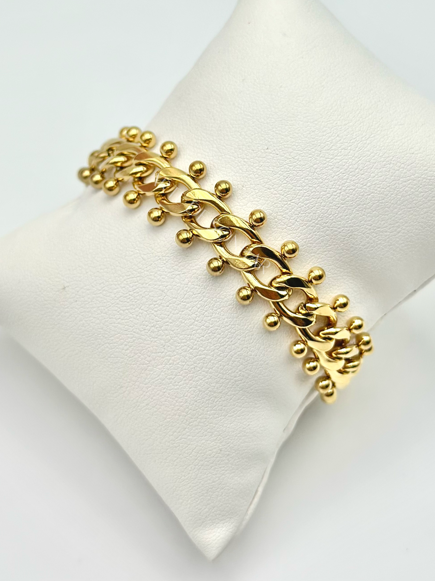 Pulseira dourada de malha aberta pequena com bolinhas